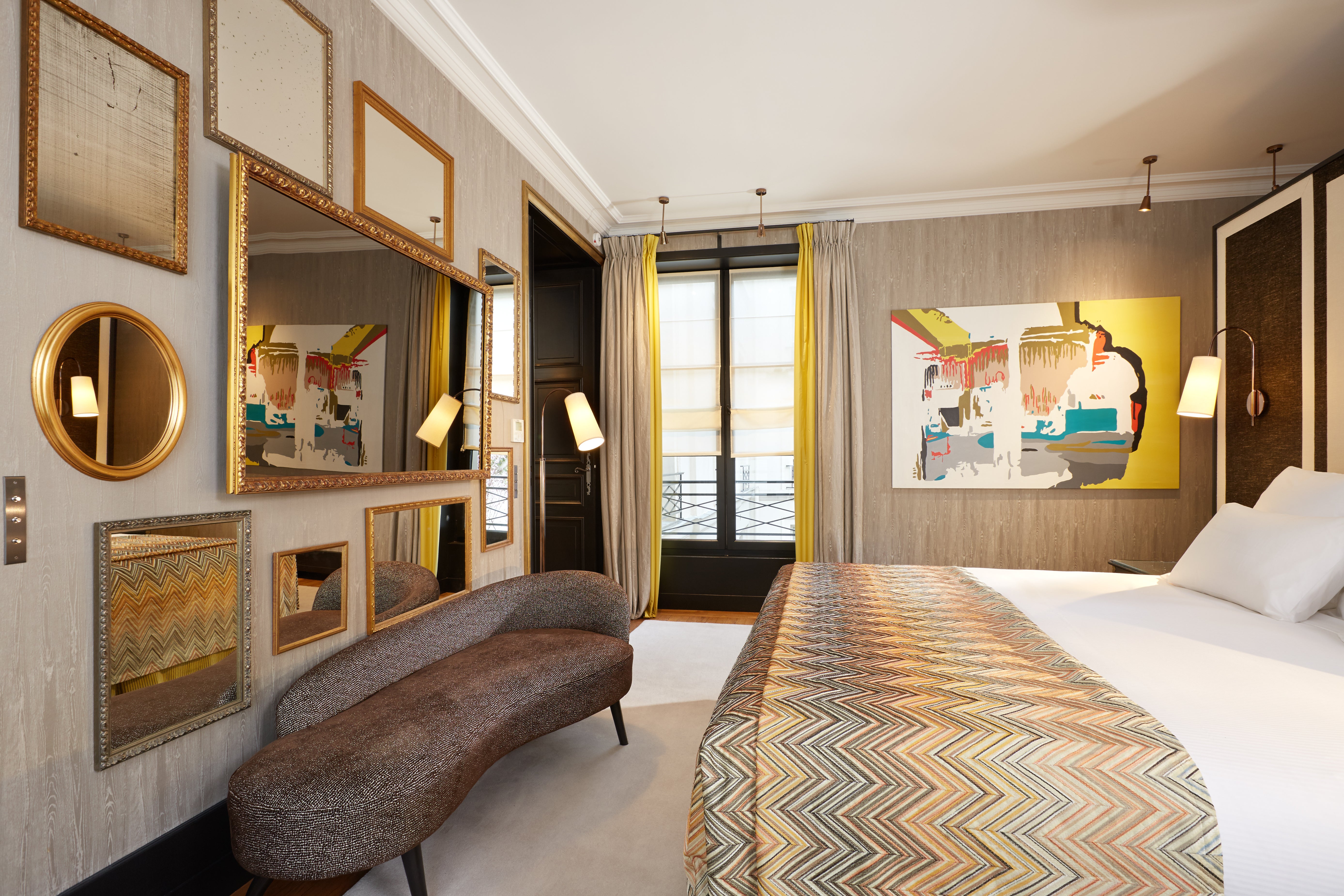 Mirrors and art adorn the bold Suite de la Reine