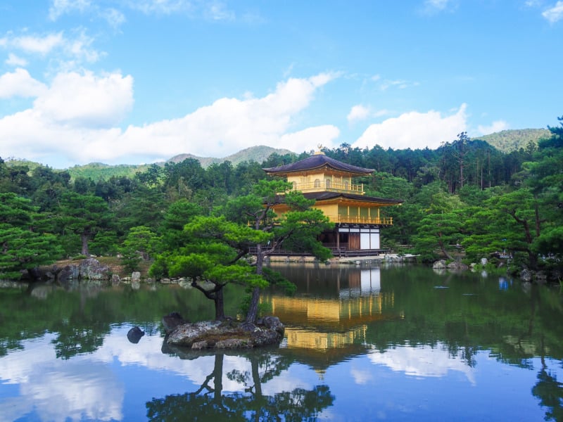 Serene pond at Kinkaku-ji The Golden Pavilion in Kyoto surrounded by lush greenery