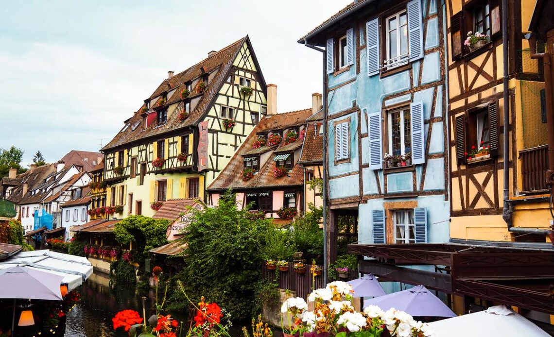 Historic houses, flowers, and canal view at La Petite Venise in Colmar, Alsace, France