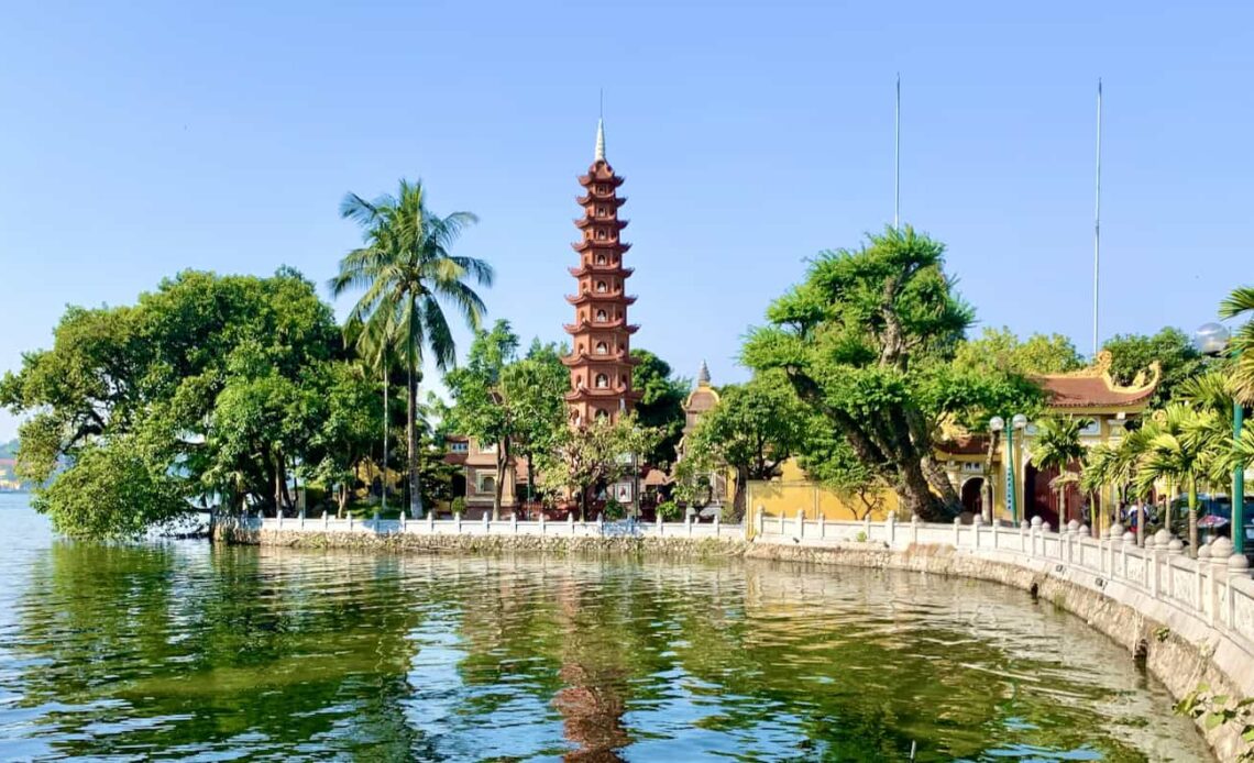 A sunny day in Hanoi, Vietnam near the lake with a historic pagoda in the background