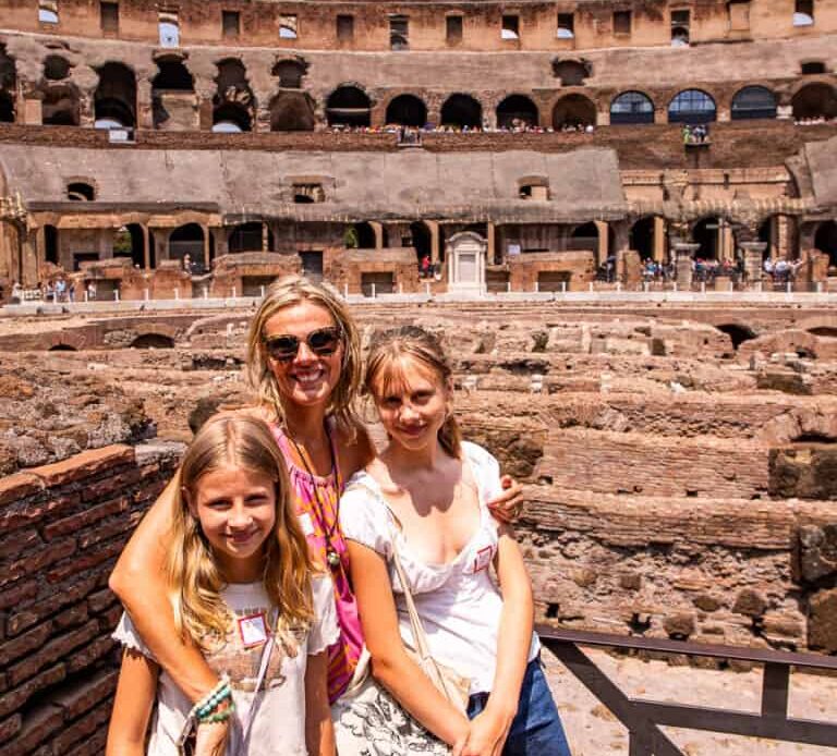 caz and the girls smiling at camera inside colosseum