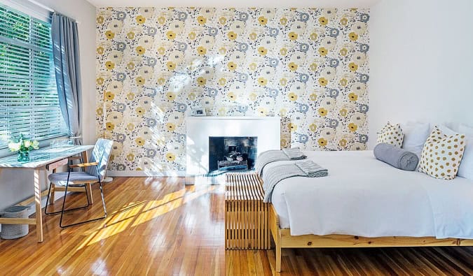 A light-filled guest room with floral wallpaper, a fireplace, hardwood floors, desk, and crisp white queen bed at Casa Legado in Bogotá,...</p>
</div>
<p><a href=