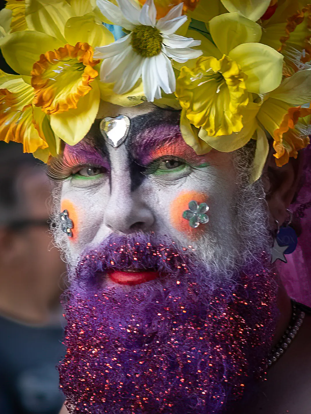 Glitter, rhinestones and flowers adorn a reveler during a Pride parade in New Orleans.