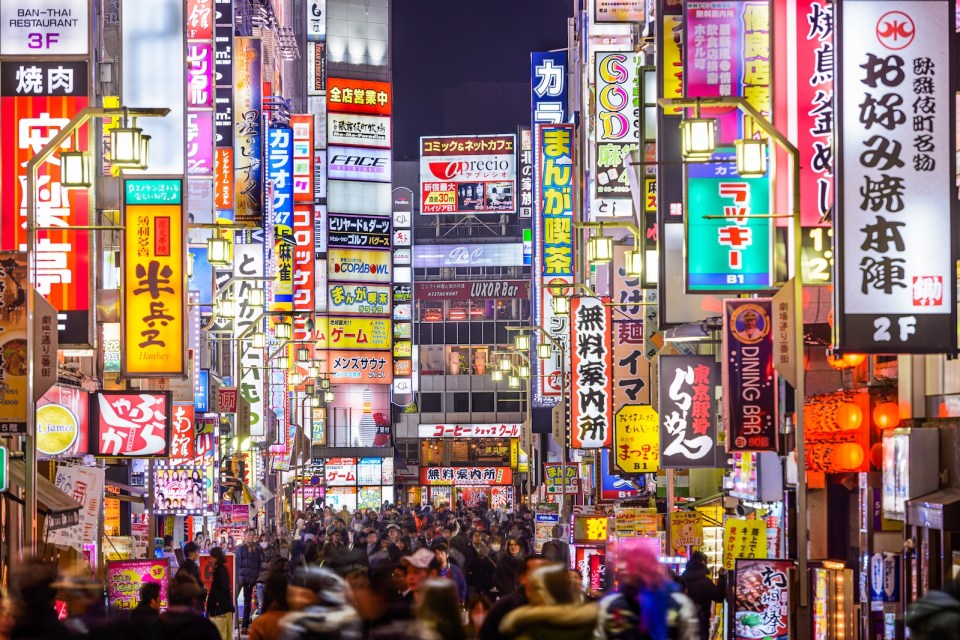 Signs densely line an alleyway in Kabuki-cho. The area is a renown nightlife and red-light district.