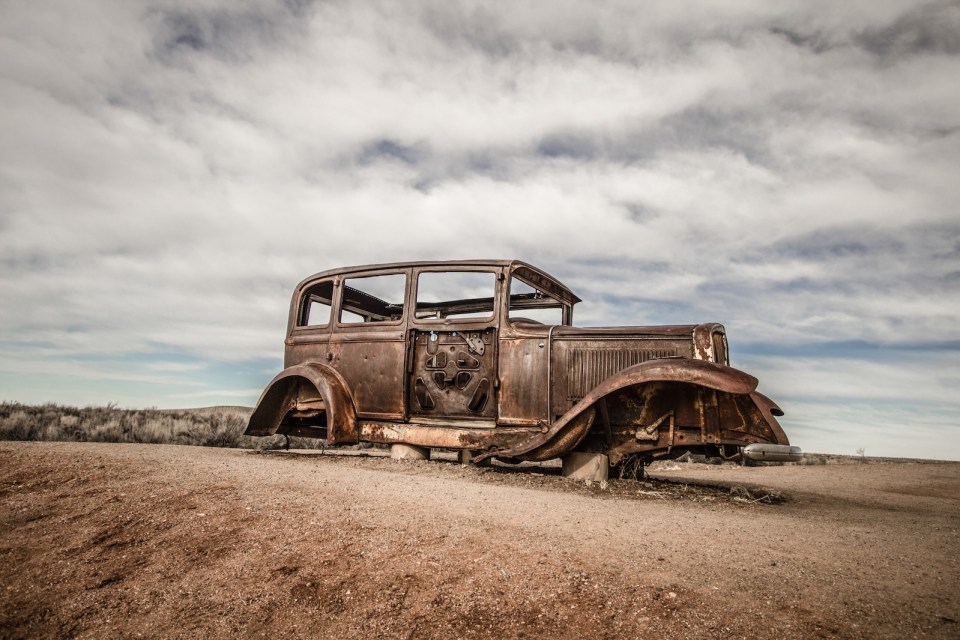 Abandoned Car in the American southwest desert at the Petrified Forest Painted Desert National Park