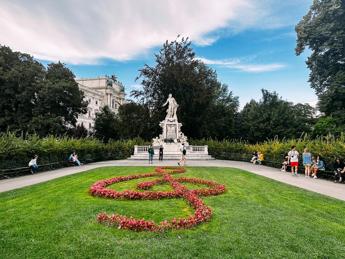 Mozart Statue in Burggarten Park, Vienna - Iconic landmark with lush gardens and vibrant floral treble clef (source: [Moz](https://imageseo.io/alt-text-seo/))