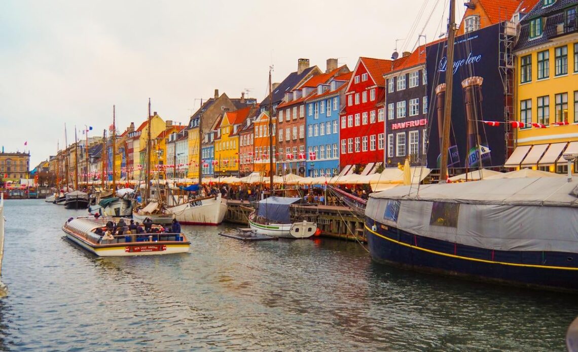 Colorful Nyhavn canal with historic houses and ships in Copenhagen