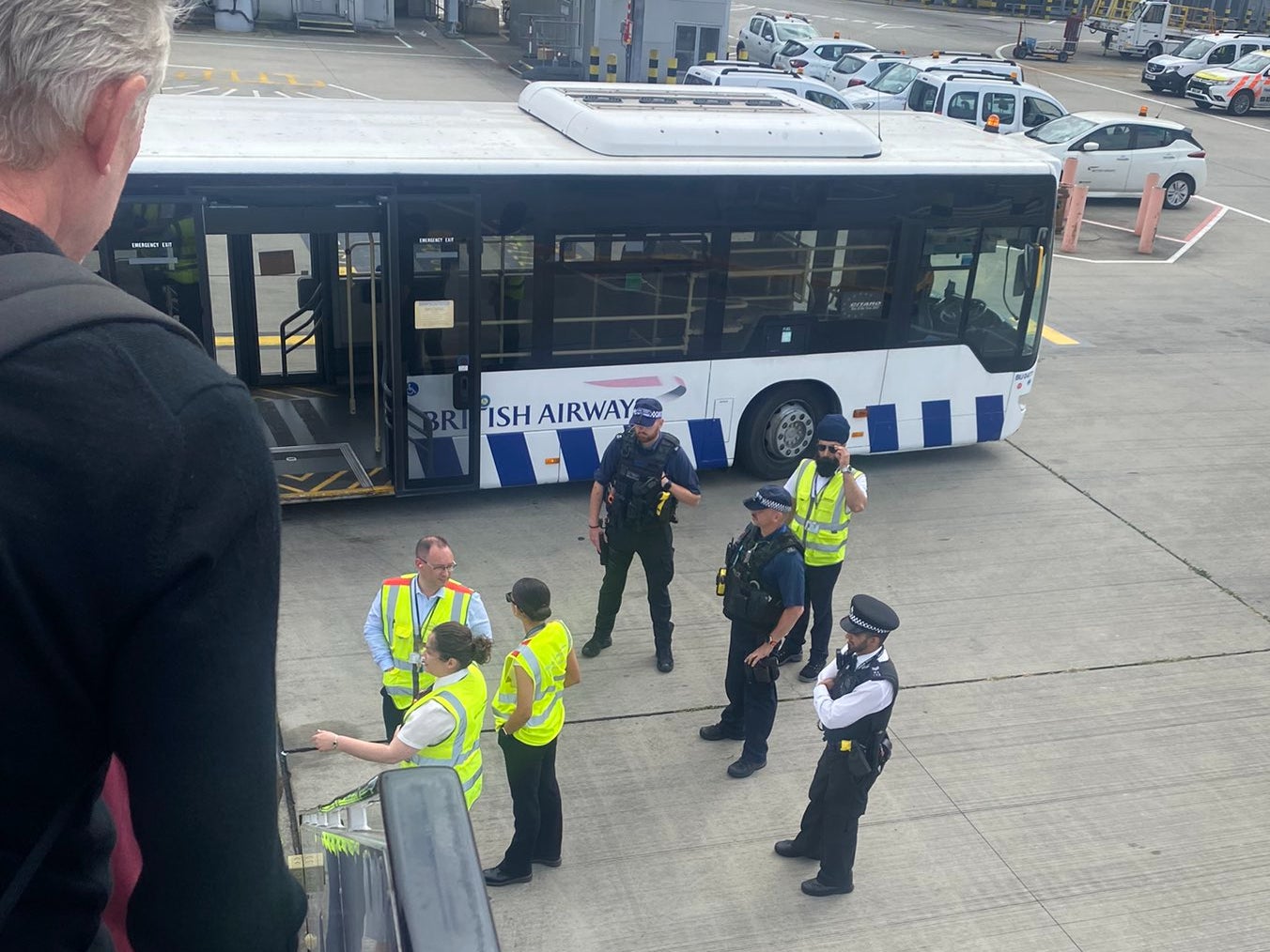 Wrong airport: British Airways staff and airport police at the foot of the stairs of a BA Airbus A321 diverted from Gatwick to Heathrow