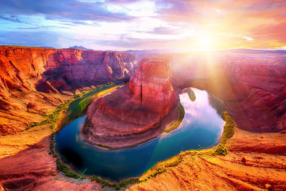 Vivid dramatic sunset over Horseshoe Bend, a famous meander on river Colorado near the town of Page. Arizona, USA