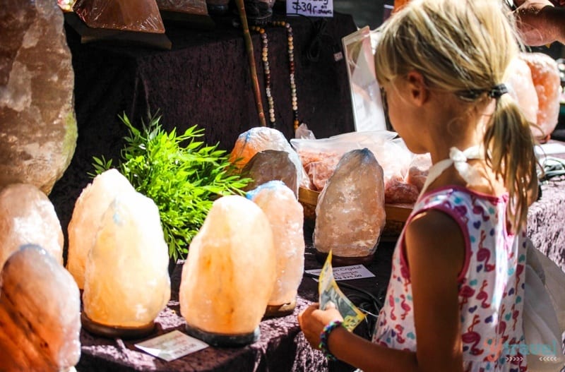 a girl looking at lamps