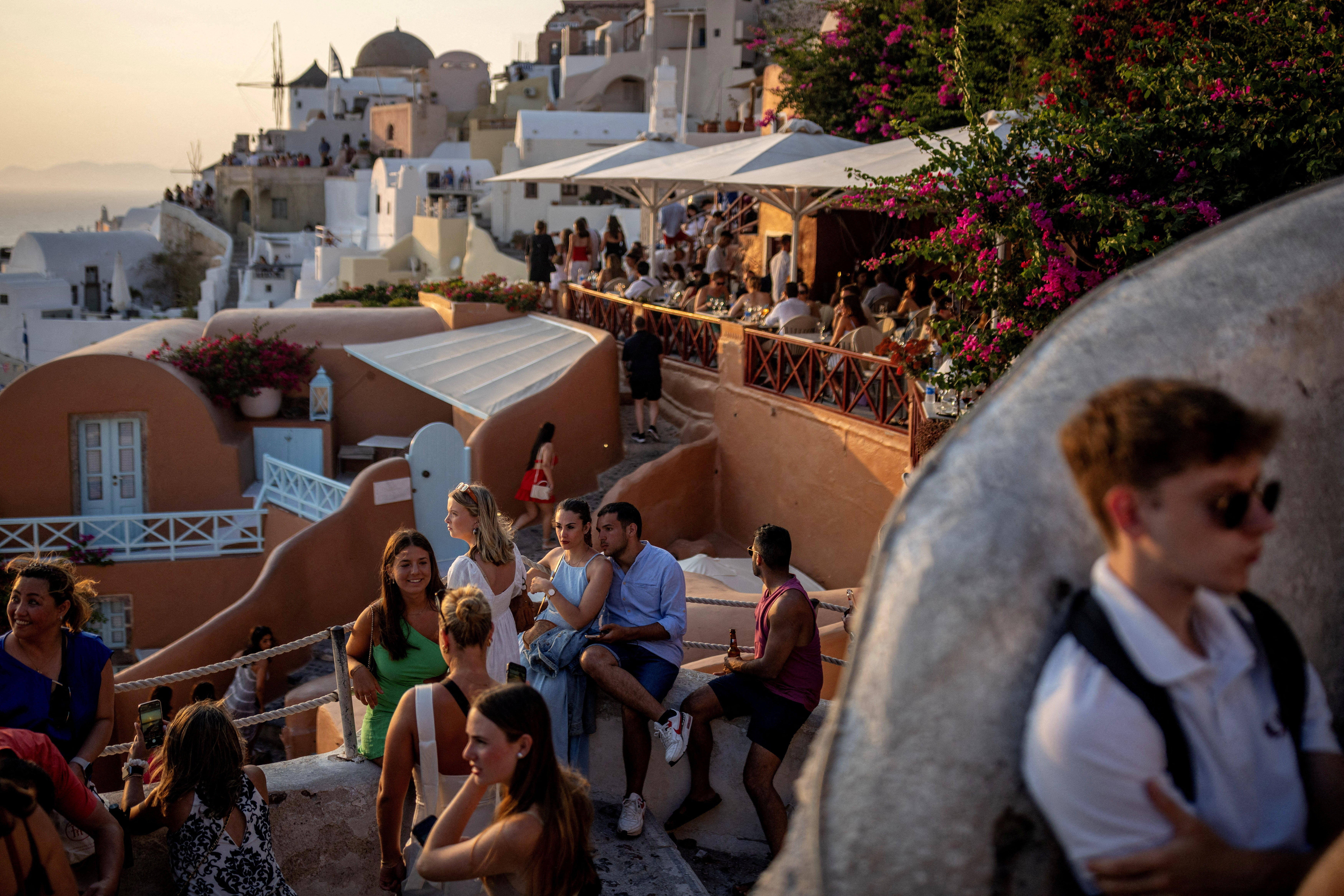 Tourists wait to view Santorin's famed sunset, on Santorini, Greece, July 25, 2024