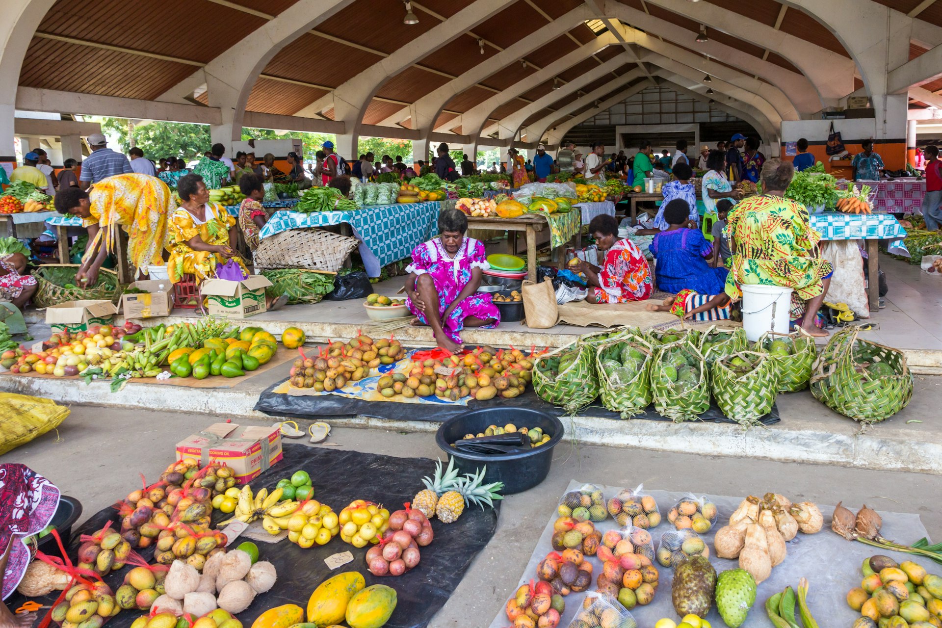 A busy market place full of colorful vegetables