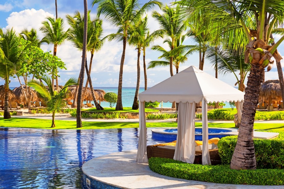 Tropical beach resort with umbrellas and lounge chairs