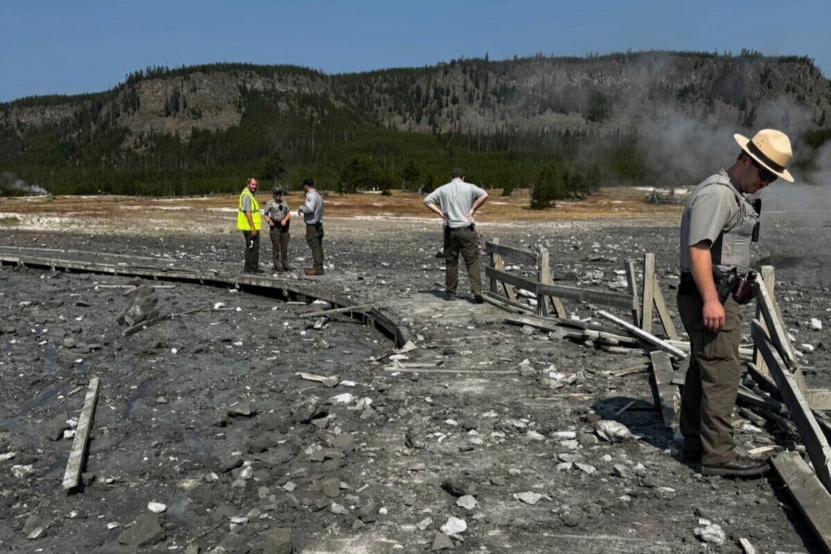 Park staff assess the damage to Biscuit Basin boardwalks after a hydrothermal explosion at Biscuit Basin in Yellowstone National Park