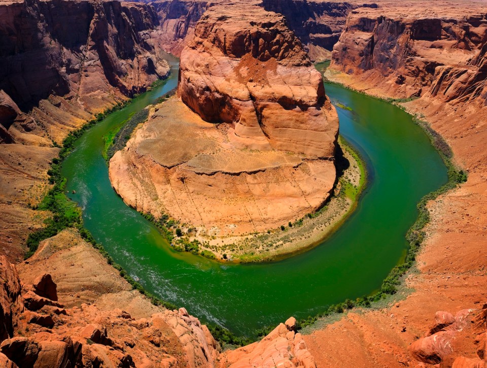 Horseshoe Bend famous view of the Green Colorado River in a canyon with red rock cliffs