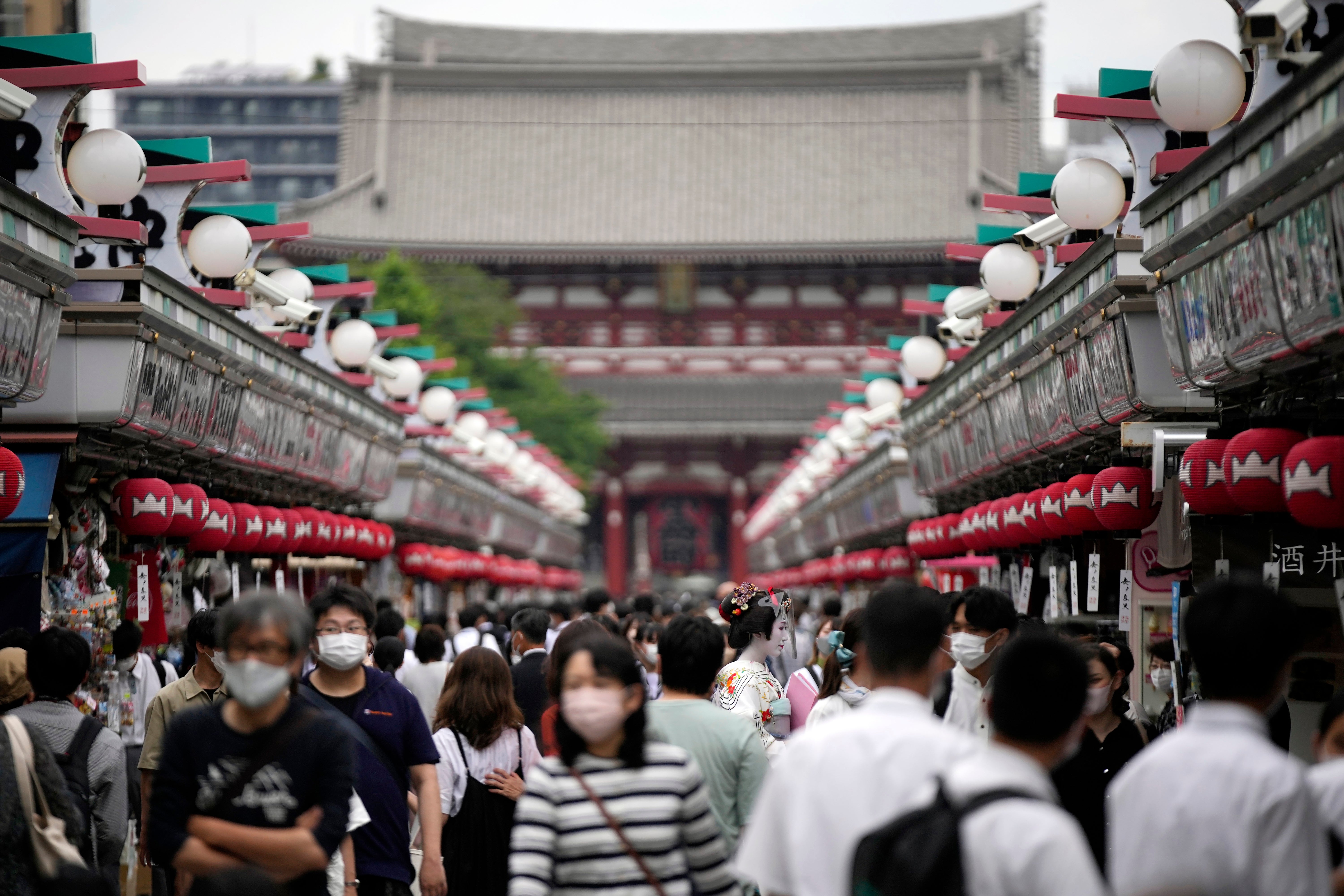 Visitors walk along a shopping street at the Asakusa district