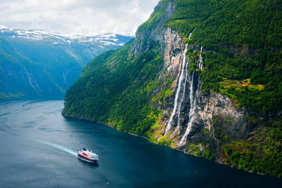 Breathtaking view of Sunnylvsfjorden fjord and famous Seven Sisters waterfalls, near Geiranger village in western Norway.