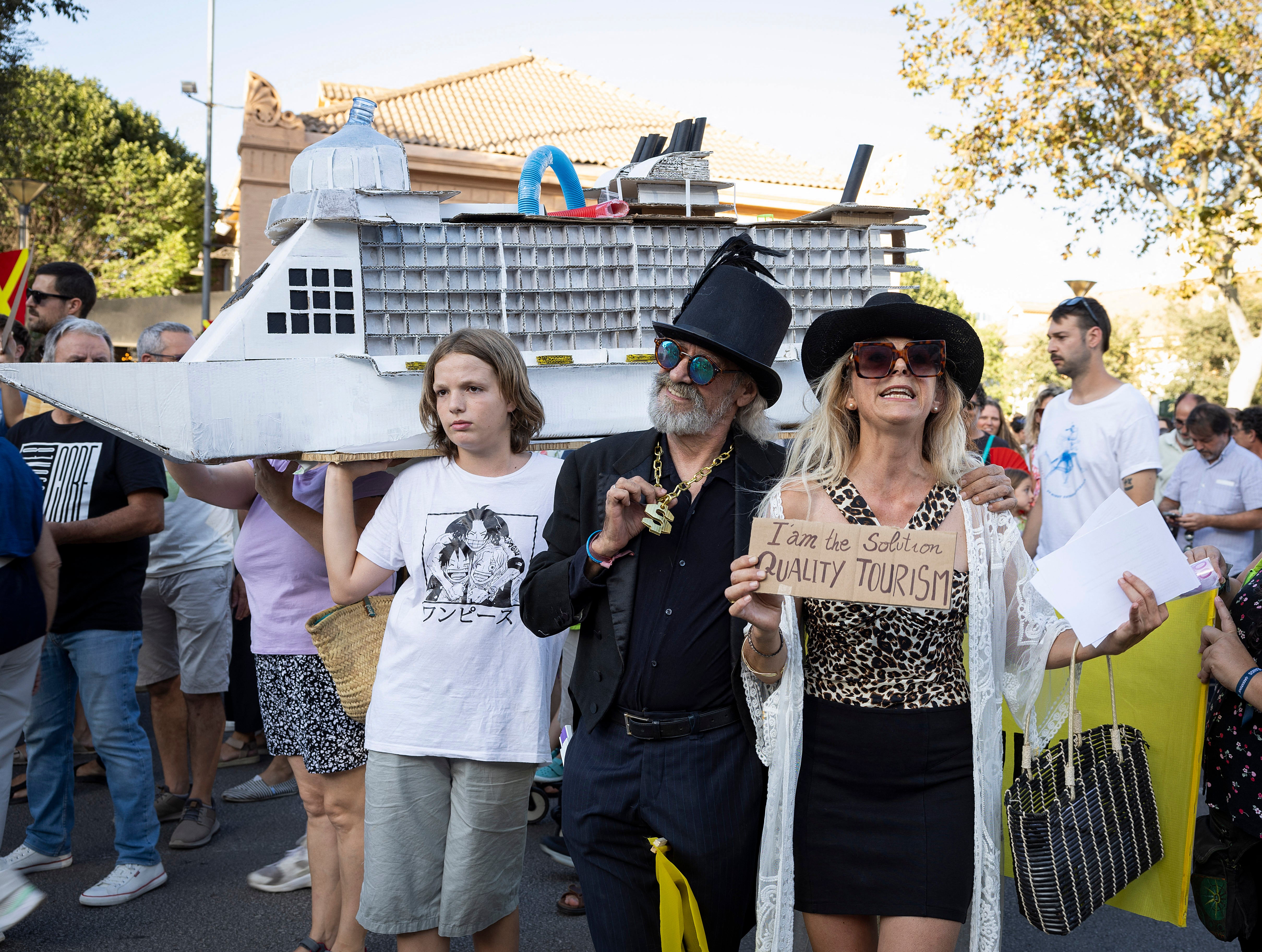 Two people do a performance as they take part in a demonstration to protest against overtourism and housing prices on the island of Mallorca in Palma de Mallorca on July 21, 2024