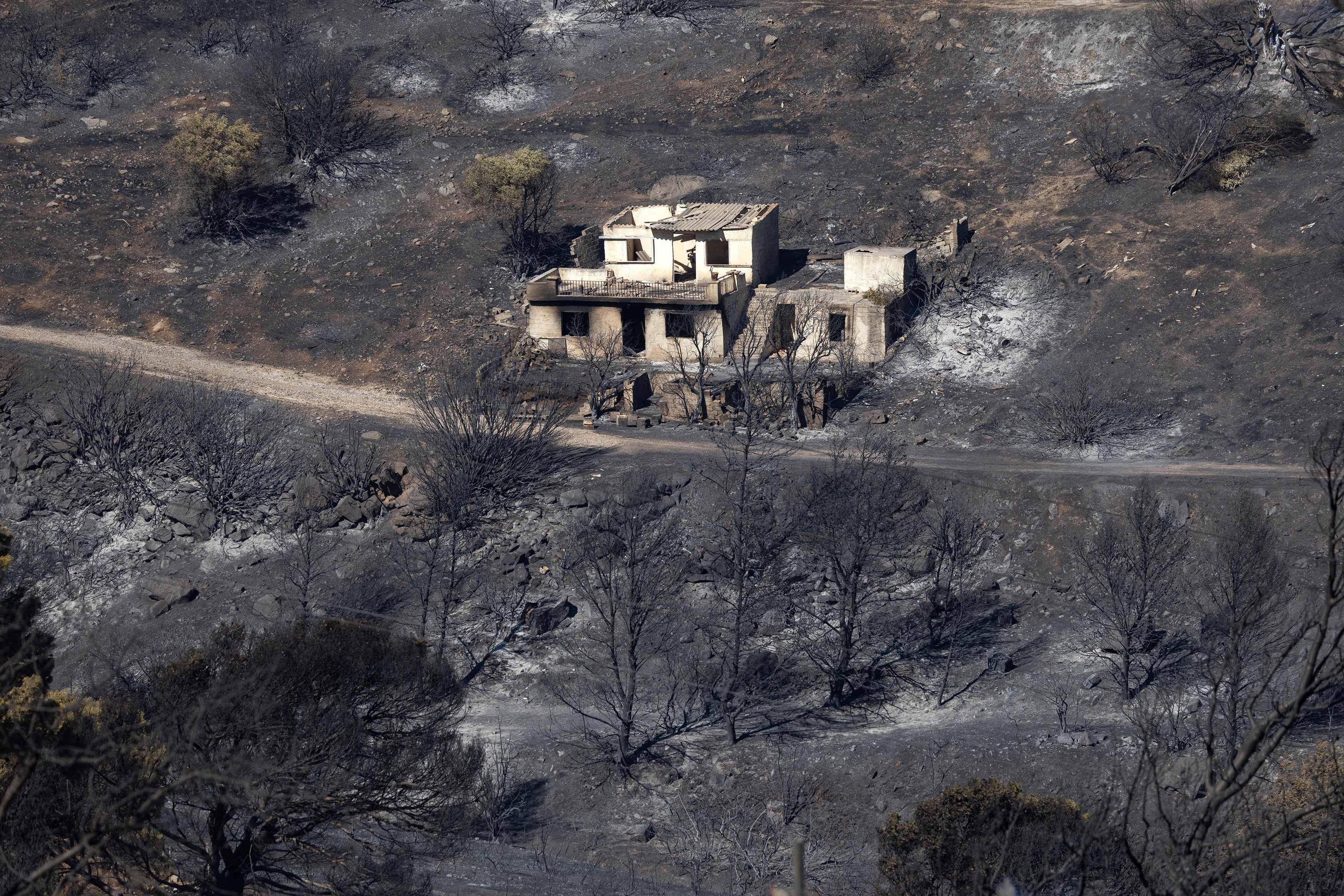 A destroyed home is seen amidst a burnt area after a wildfire at Keratea area, southeast of Athens, Greece