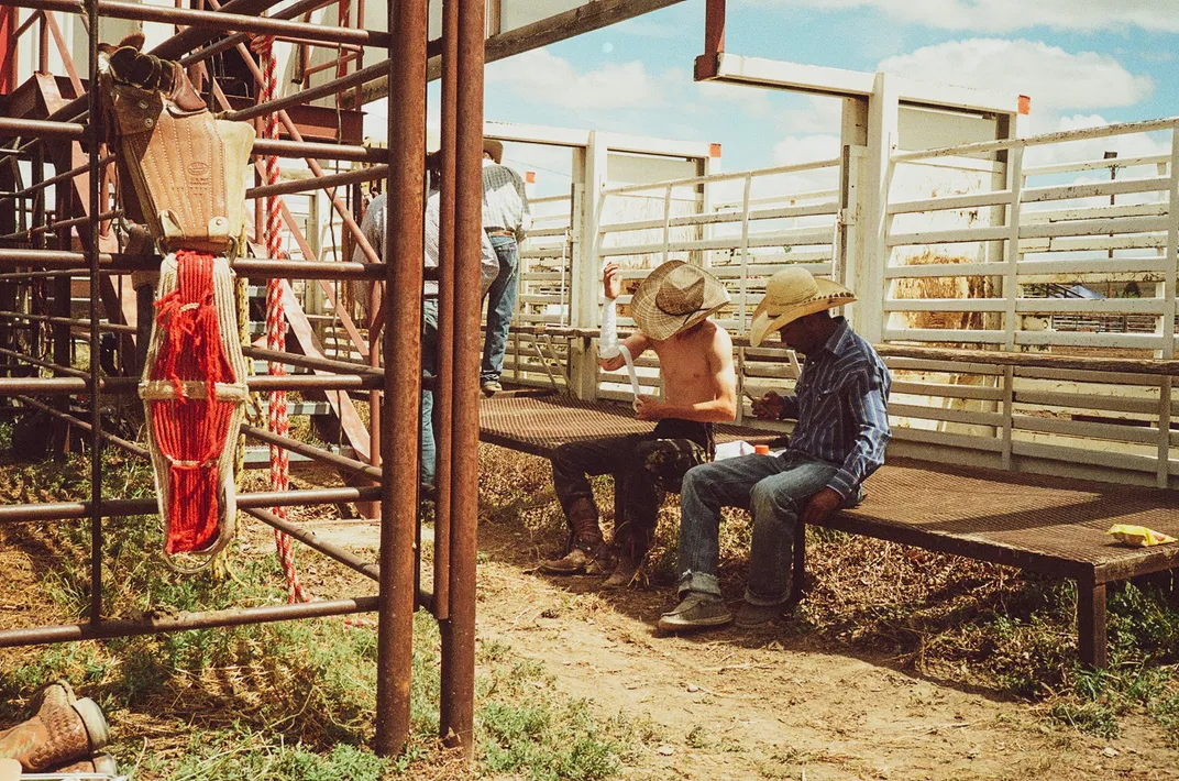 Ranch hands observe the rodeo