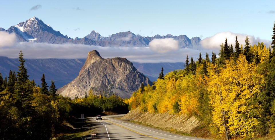 Mountains in the Chugach Range stand above the clouds rising from the Valley in Alaska North America