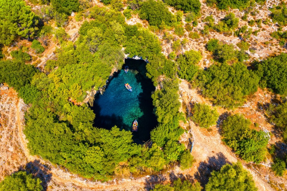 Famous Melissani lake on Kefalonia island, Karavomylos, Greece. On top of Melissani Cave (Melissani Lake) in Karavomylos village in Kefalonia island , Greece. Melissani Cave viewed from above.