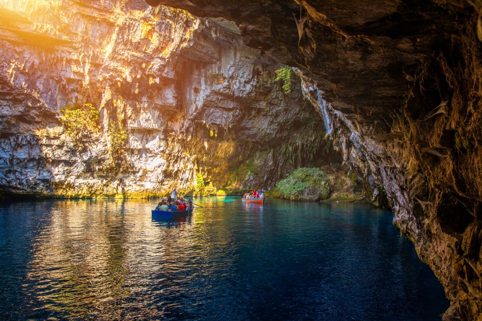 Melissani lake on Kefalonia island, Greece. Melissani Cave (Melissani Lake) near Sami village in Kefalonia island, Greece. Tourist boat on the lake in Melissani Cave, Kefalonia Island, Greece