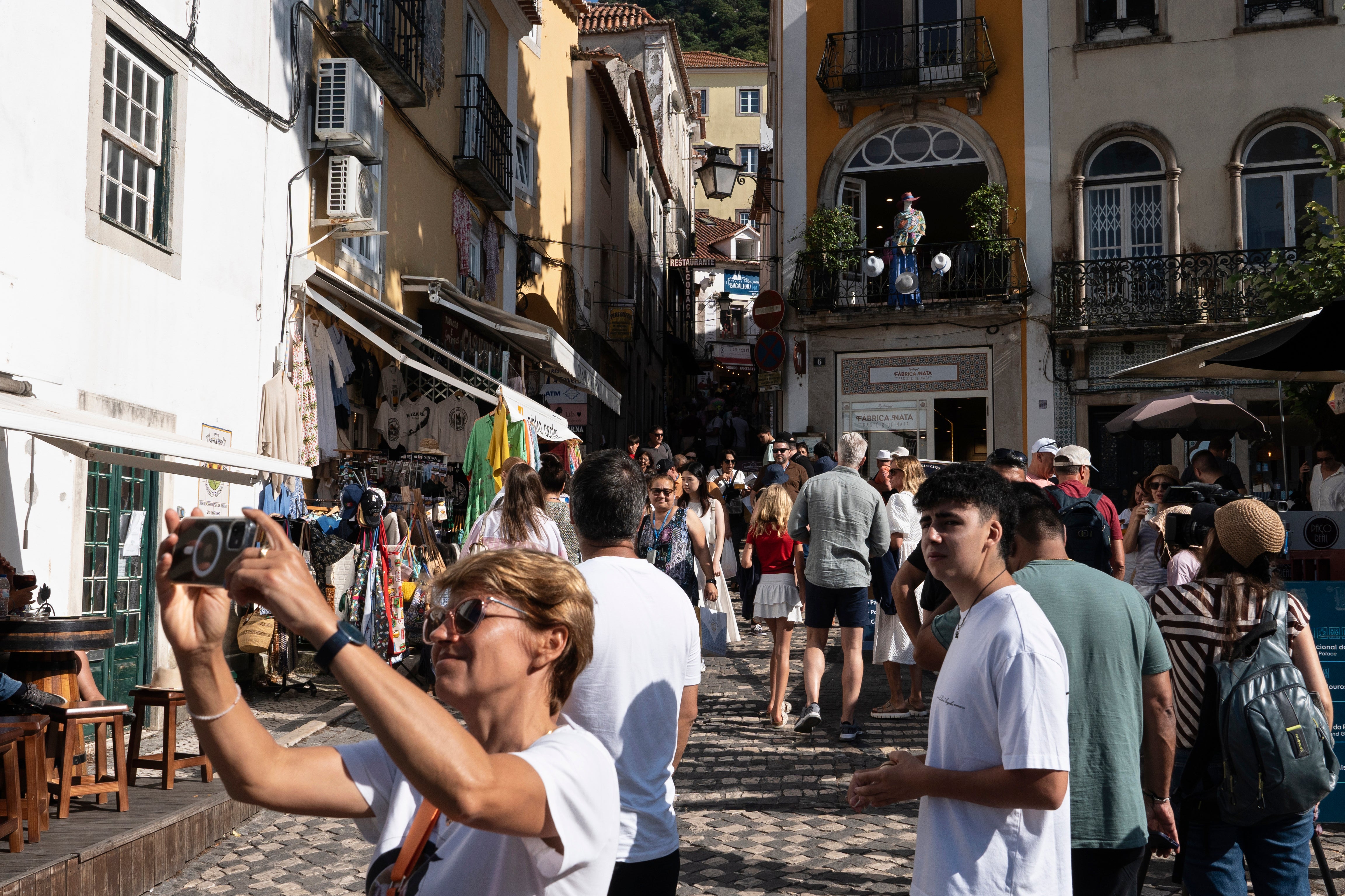 Tourists visit the old center of Sintra, Portugal, Friday, August 9