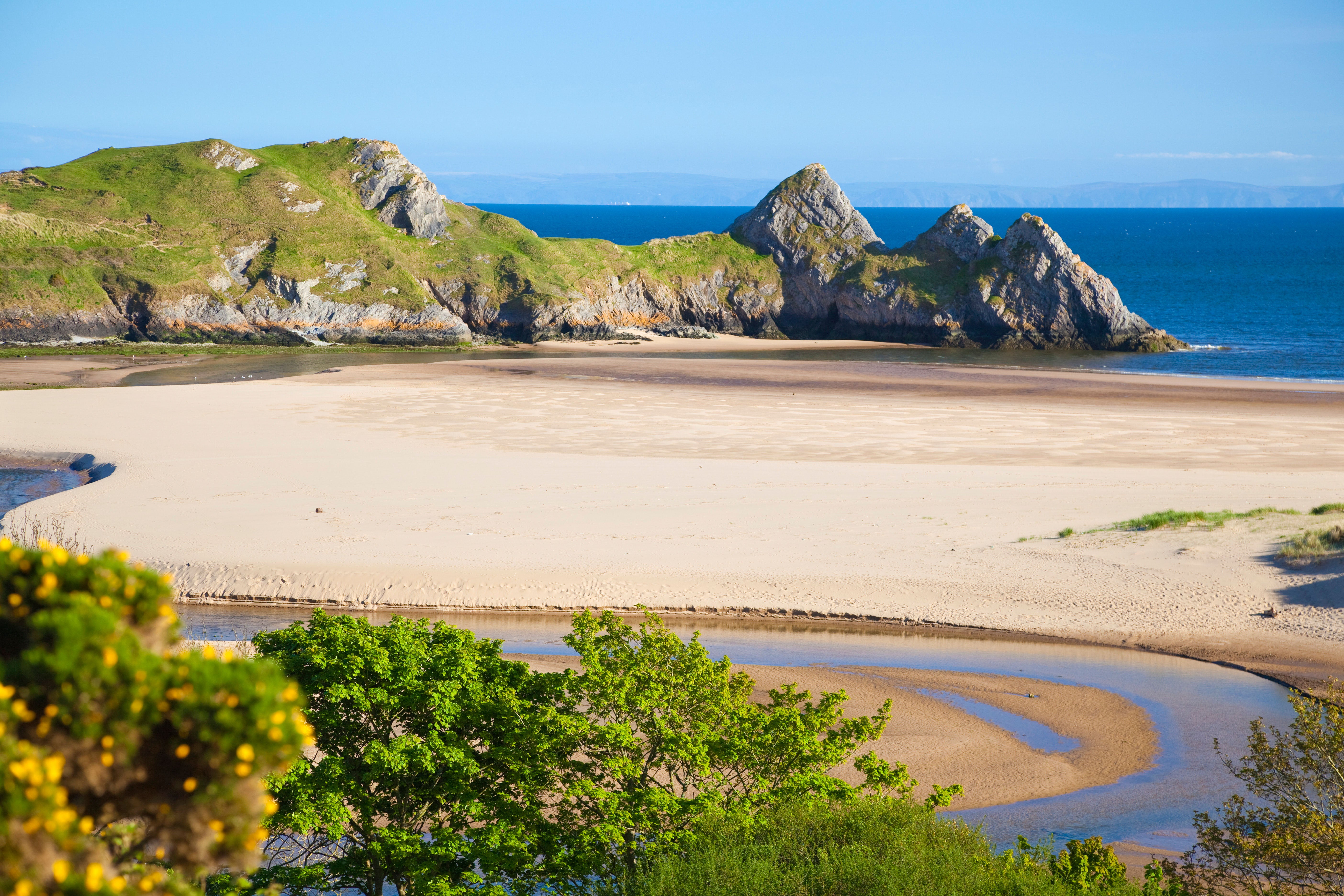 A coastal view of the Three Cliffs Bay on the Gower Peninsula