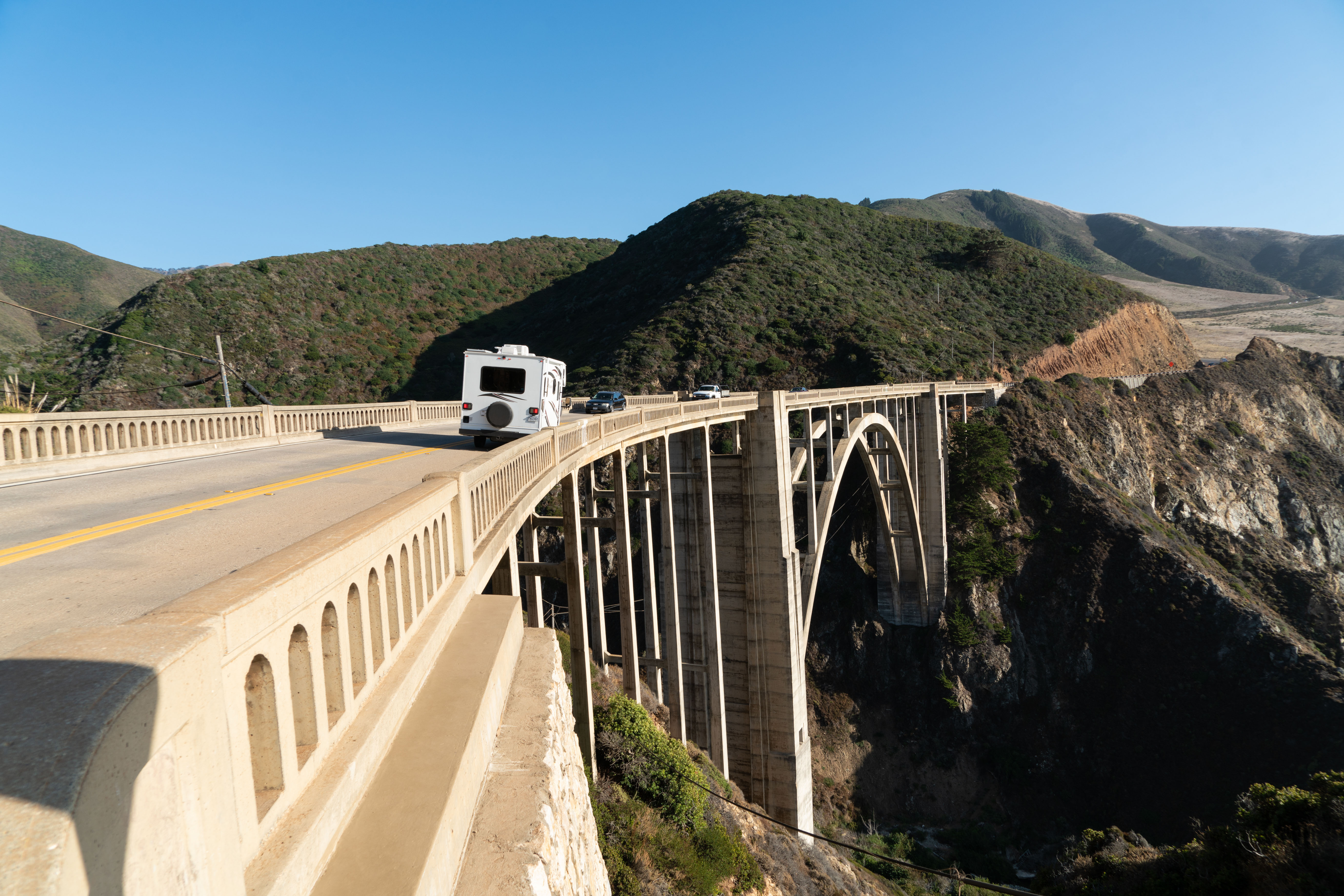 A camper drives across the arched Bixby Bridge in Big Sur