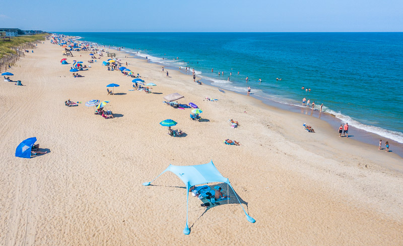 aerial of kill devil hills beach  filled with people