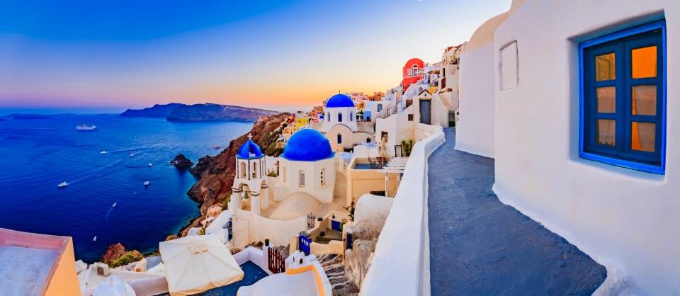 Amazing view with white houses in Oia village on Santorini island in Greece.