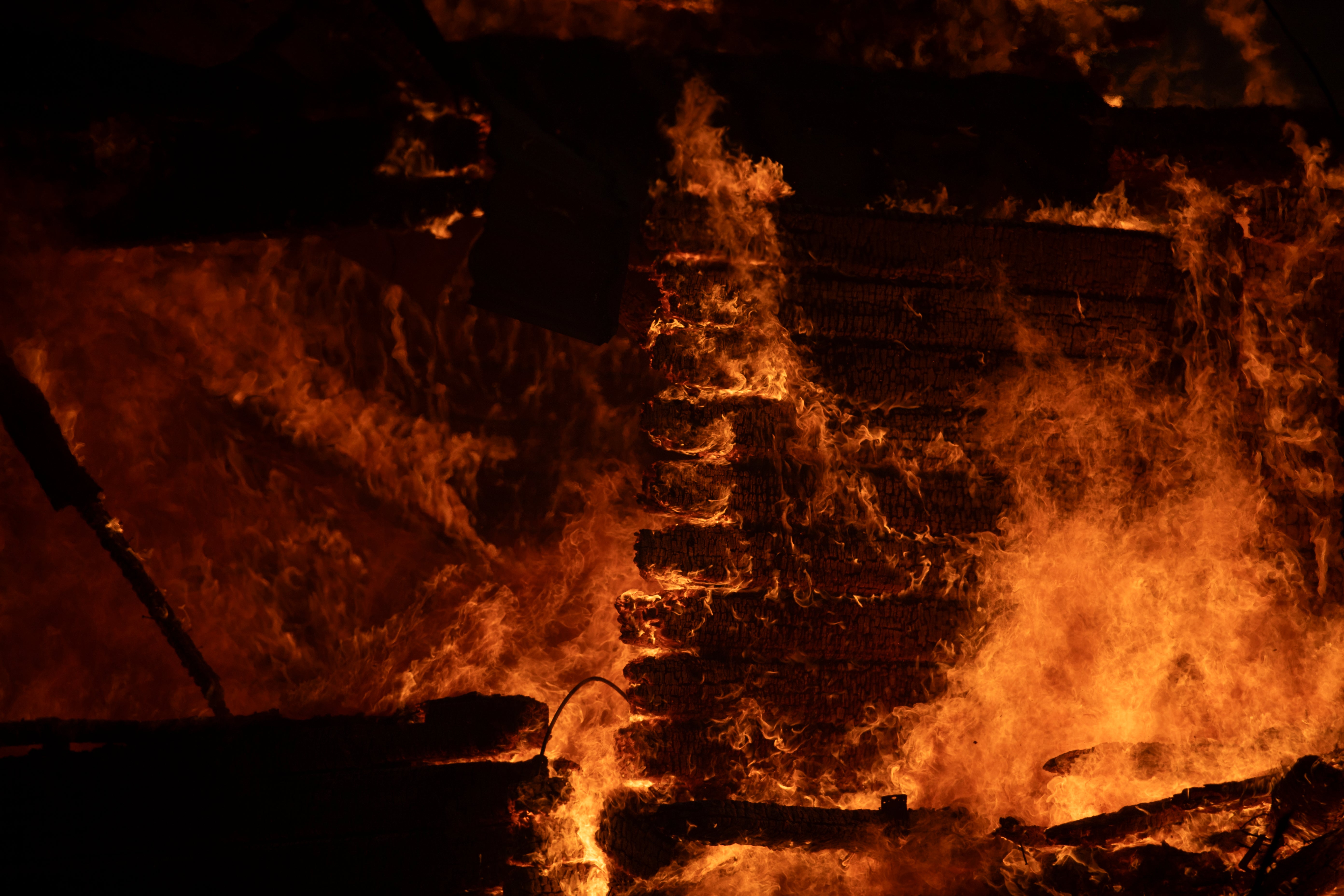 A house burns in Varnava village during a wildfire, north of Athens, Greece, Sunday