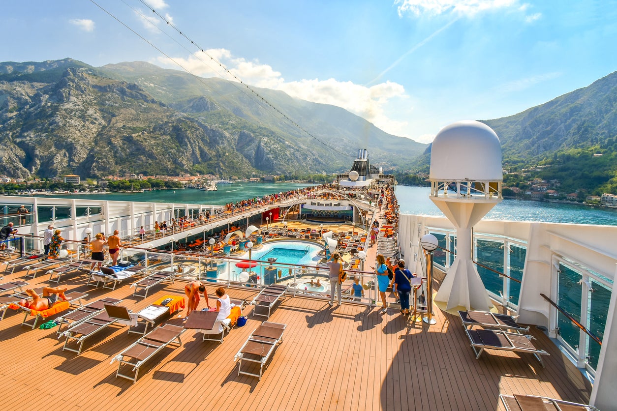 Crowded upper deck of the MSC Musica cruise ship as it pulls into the harbor of Kotor Montenegro on Boka