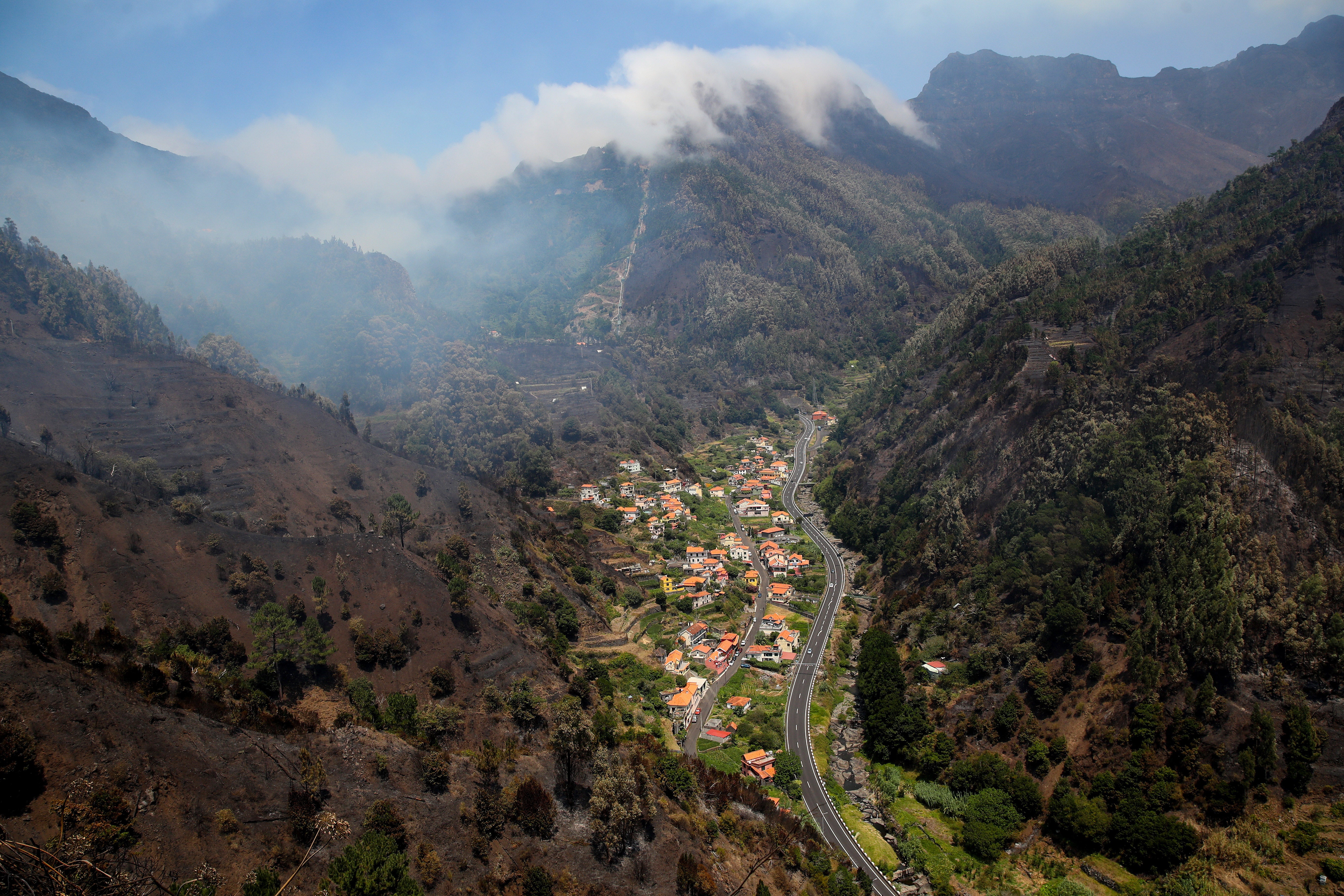 Smoke rises from a forest fire on the hills of Serra de Agua in Ribeira Brava in Madeira 19 August