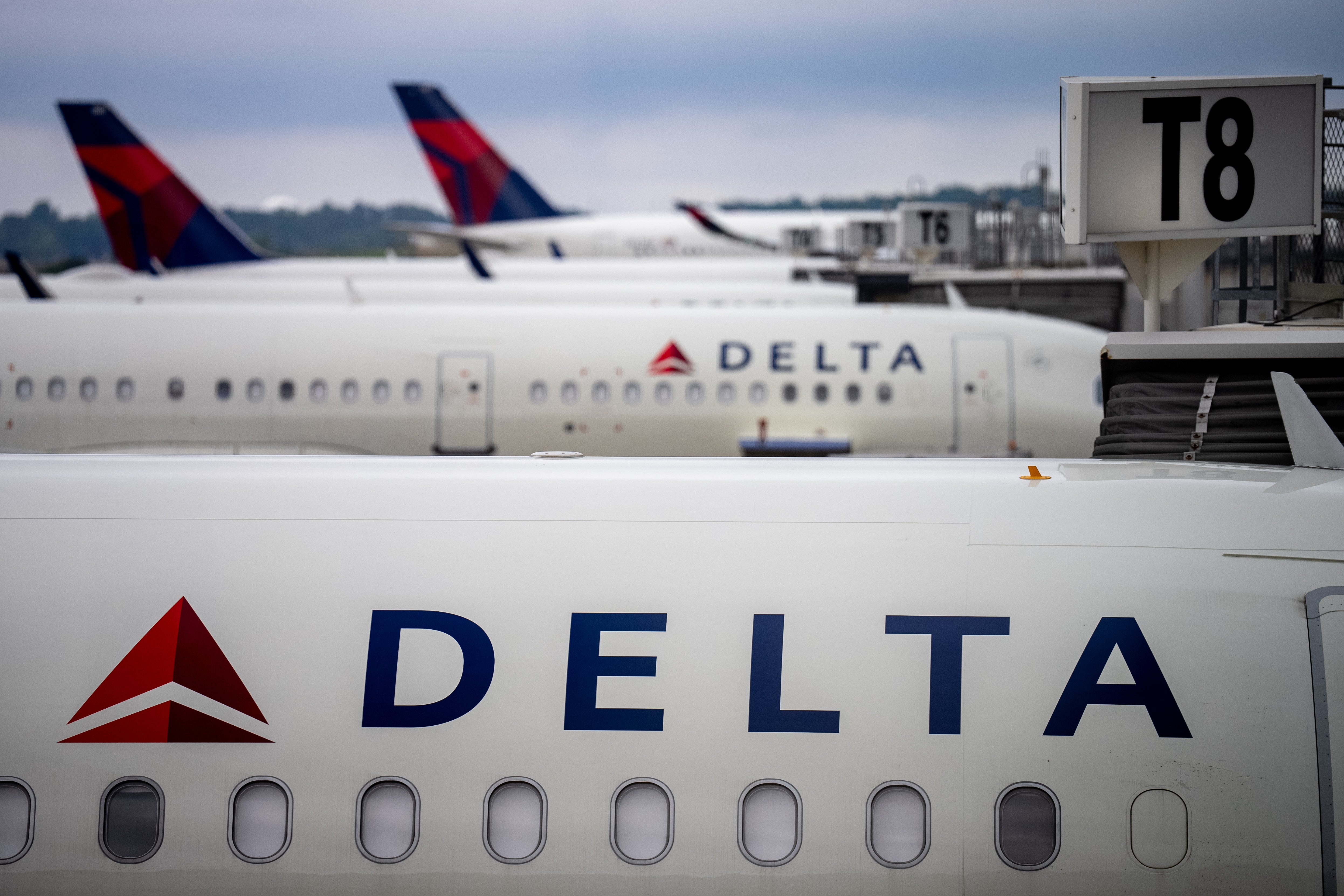 Delta airplanes sit at the Hartsfield-Jackson Atlanta International Airport. A tire exploded on a Delta airplane in a maintenance area of the airport, killing two airline employees and injuring a third