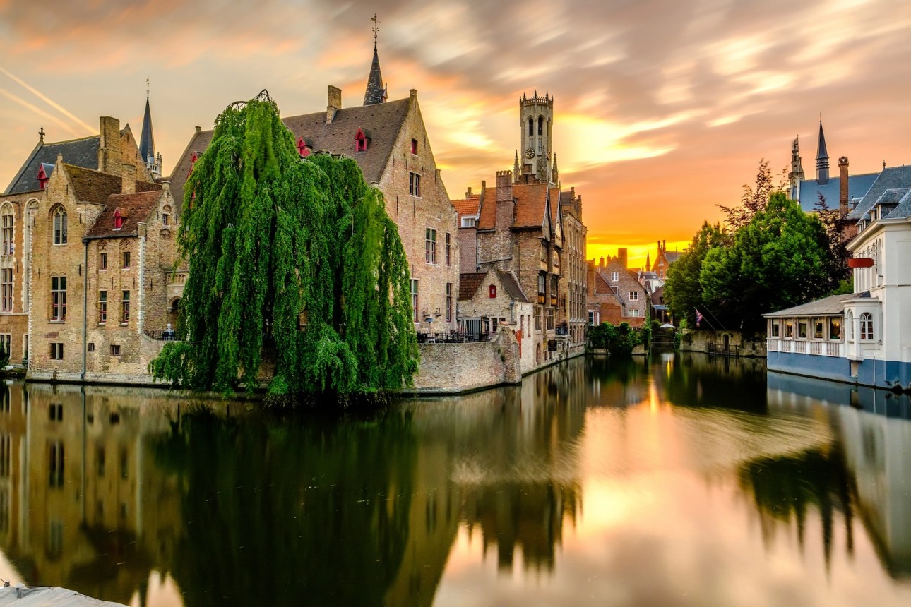 Bruges (Brugge) cityscape with water canal at sunset, Flanders, Belgium