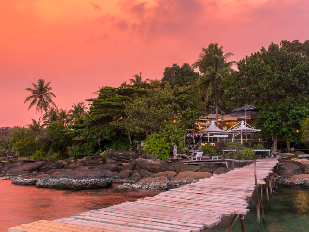 Wooden pier to a tropical island resort on Koh Kood island during sunset, Thailand.