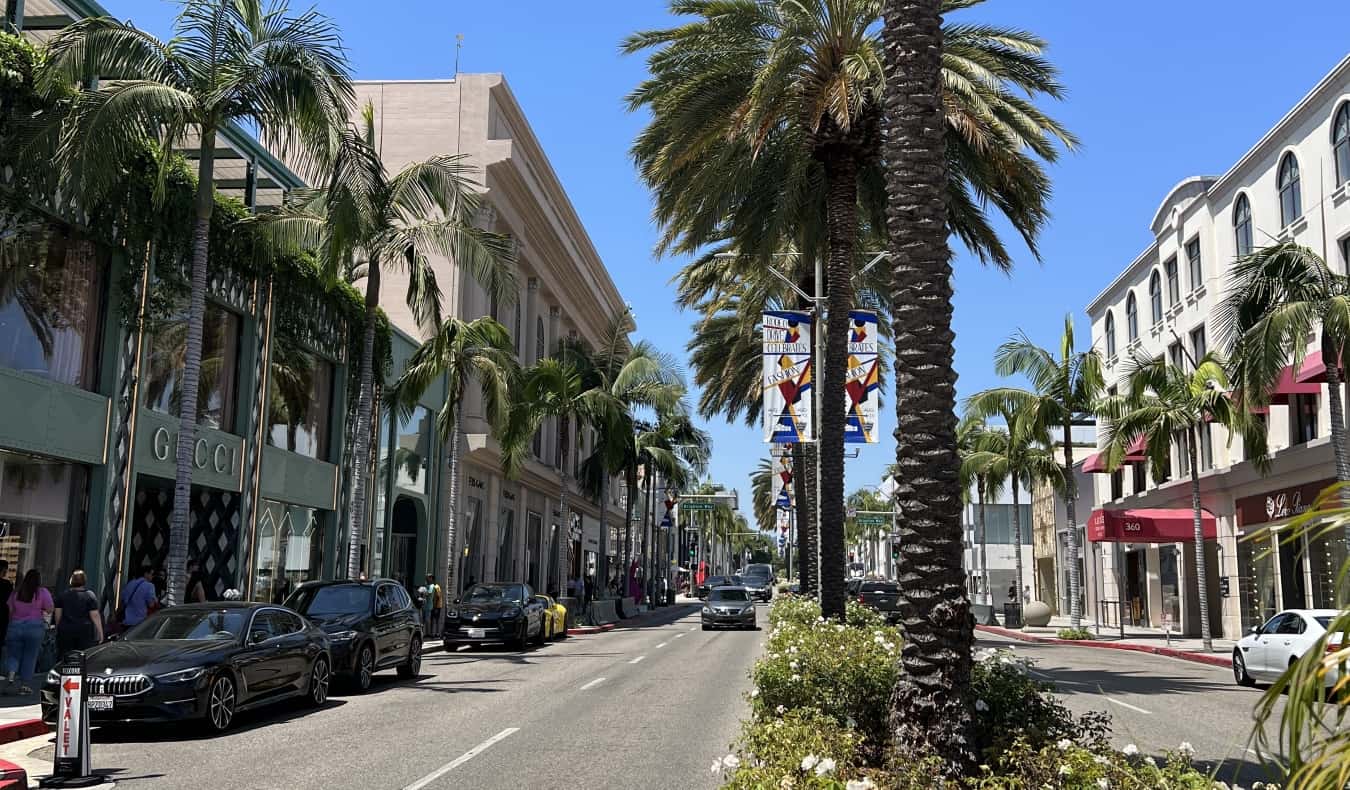 A street in Beverly Hills in Los Angeles with palm trees and expensive shops lining the streets