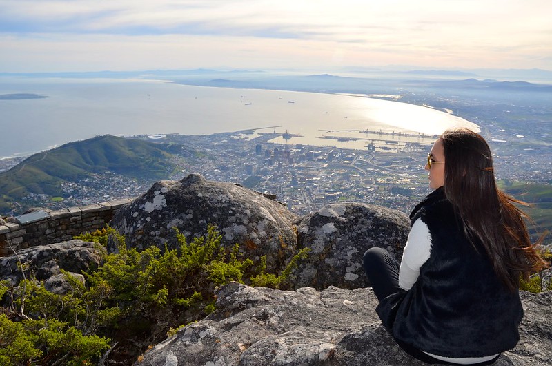 woman sitting on a rock cliff