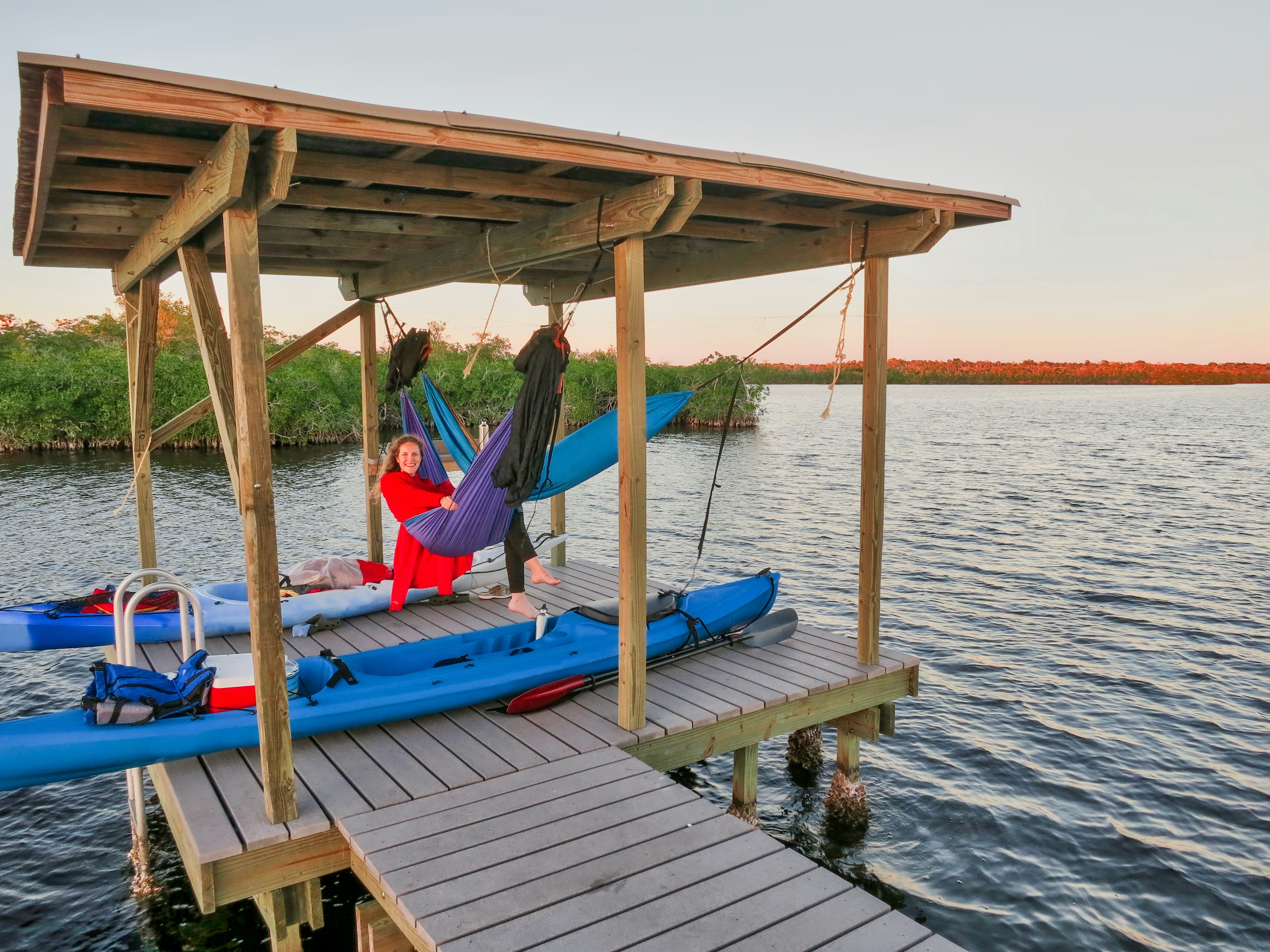 Young girl smiles in camping hammock after kayaking trip in the Florida Everglades.
621974753