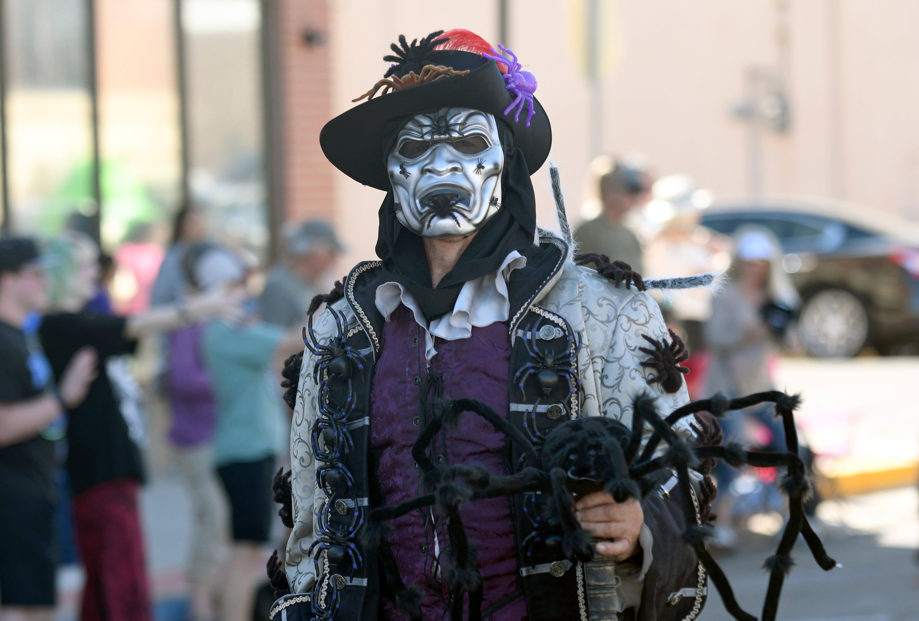 A man walks in the Tarantula Festival parade in La Junta, Colo