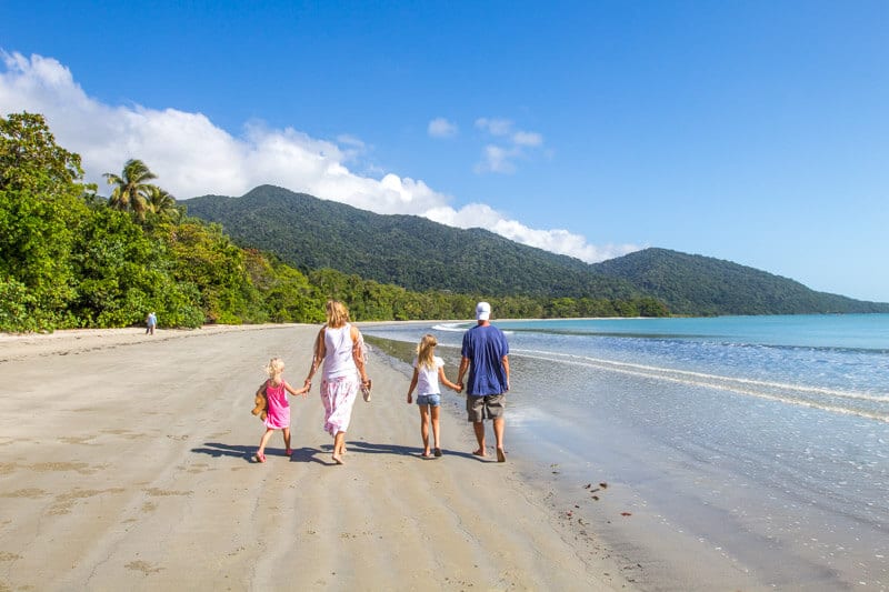 family walking along cape tribulation beach