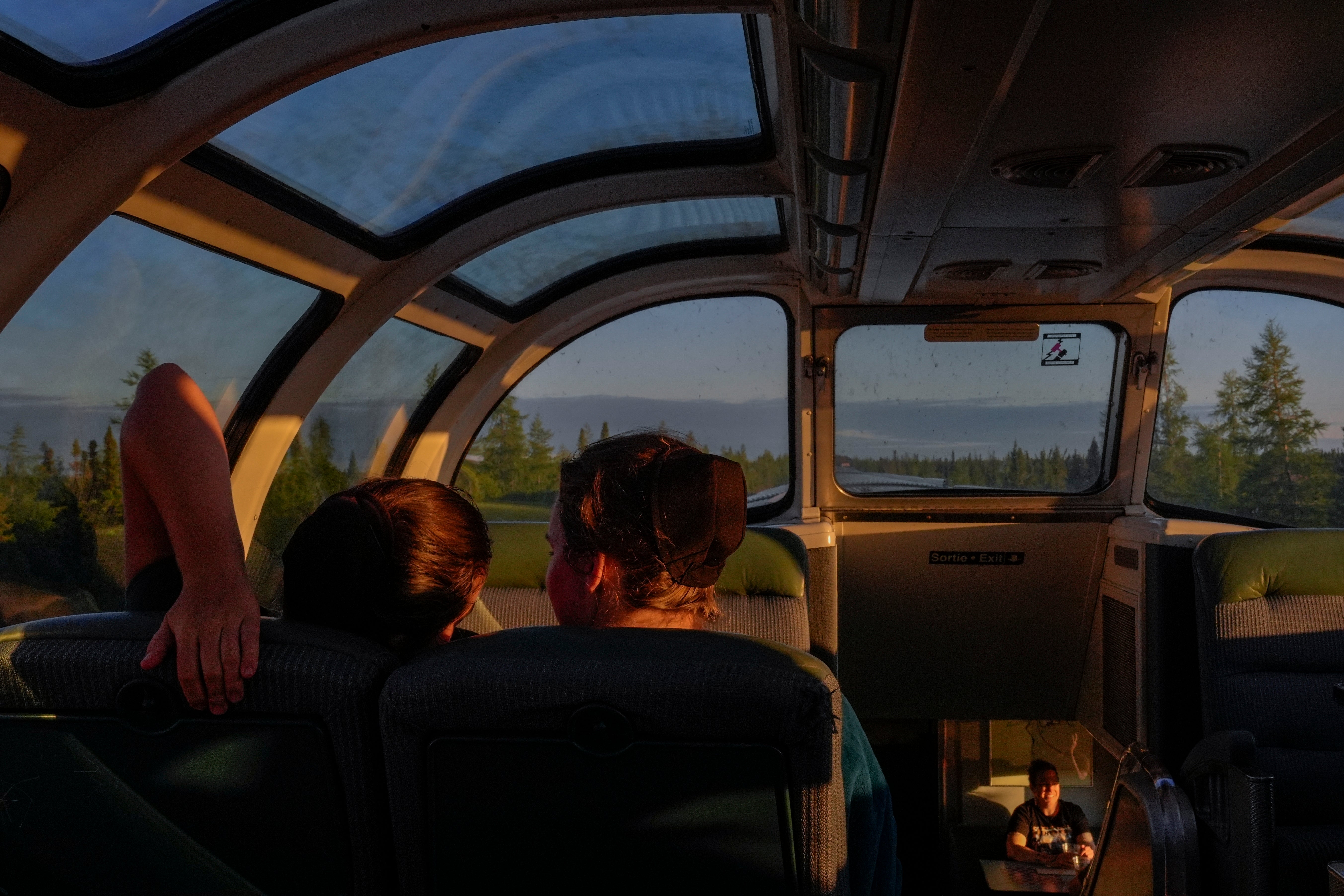 Passengers relax inside the skyline car as the sun sets Thursday, August 8, 2024