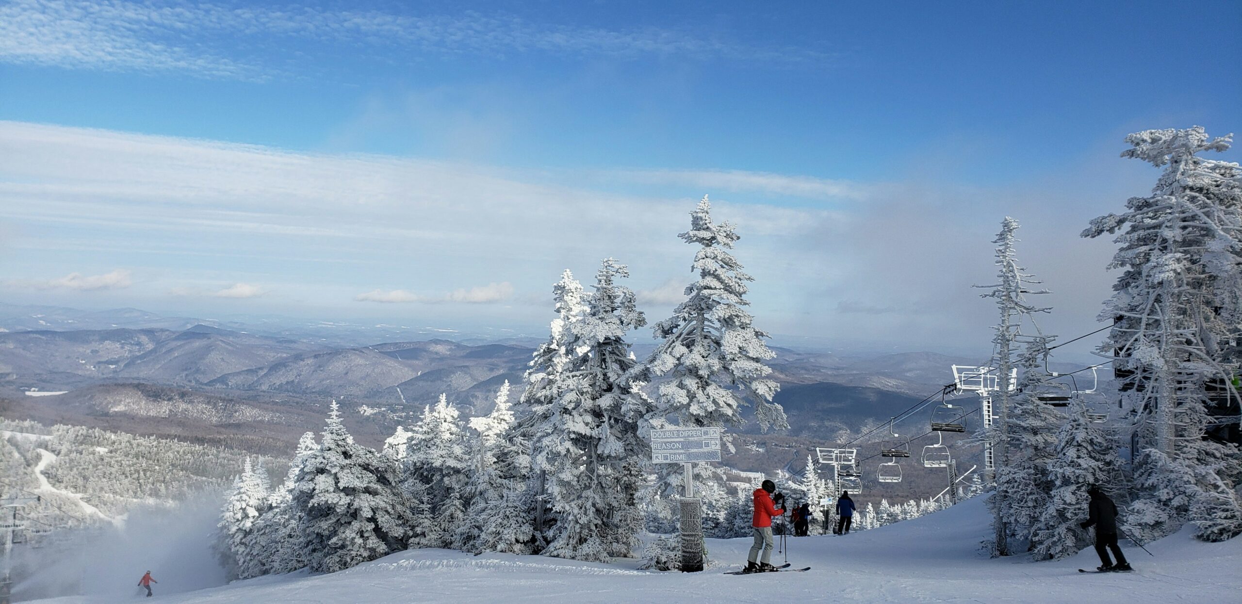 Ski slopes with snow-covered pines with a chairlift in the distance at Killington ski resort in the Vermont mountains