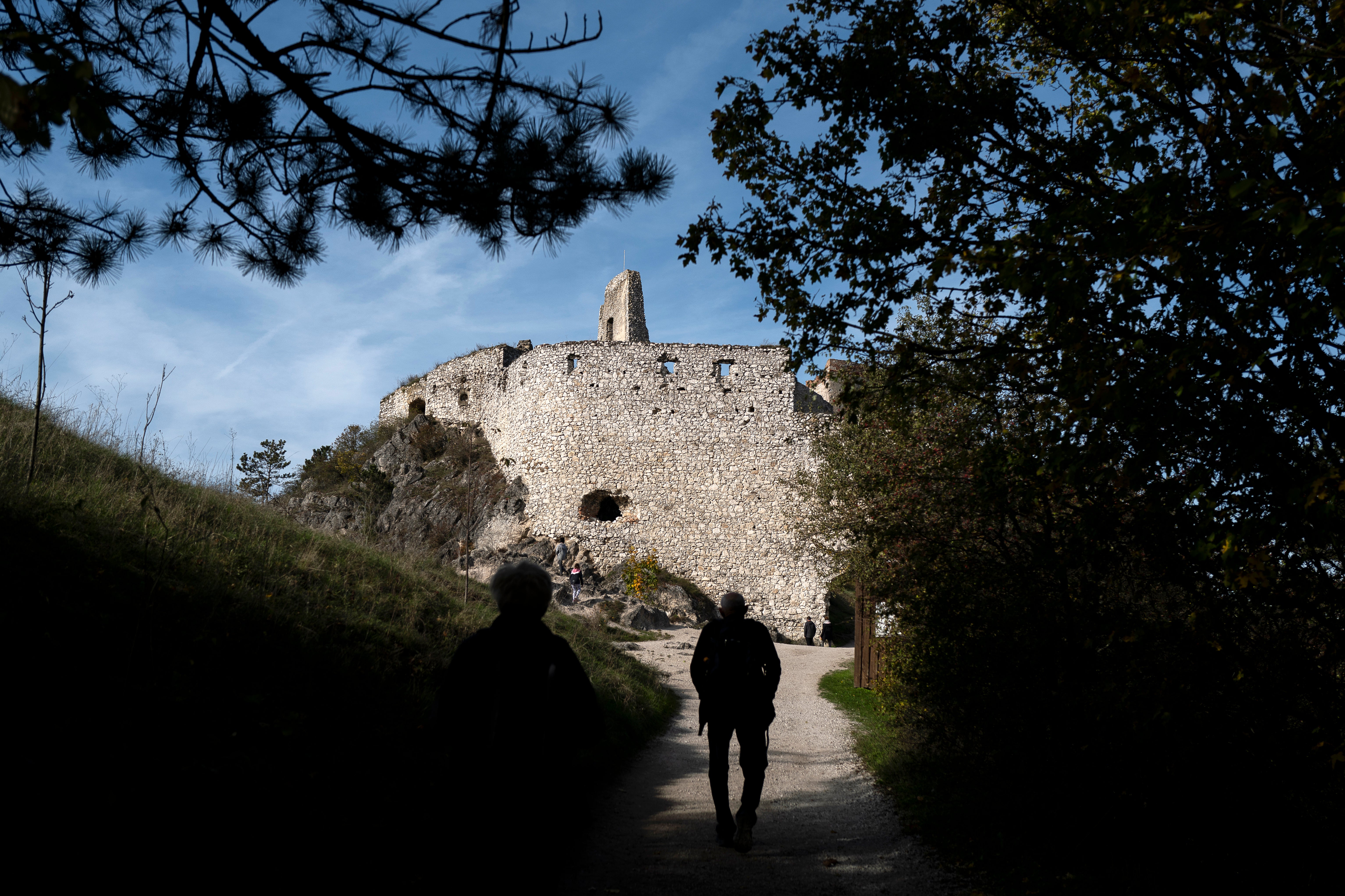 People walk towards the ruins of the former Bathory castle near Cachtice, Slovakia