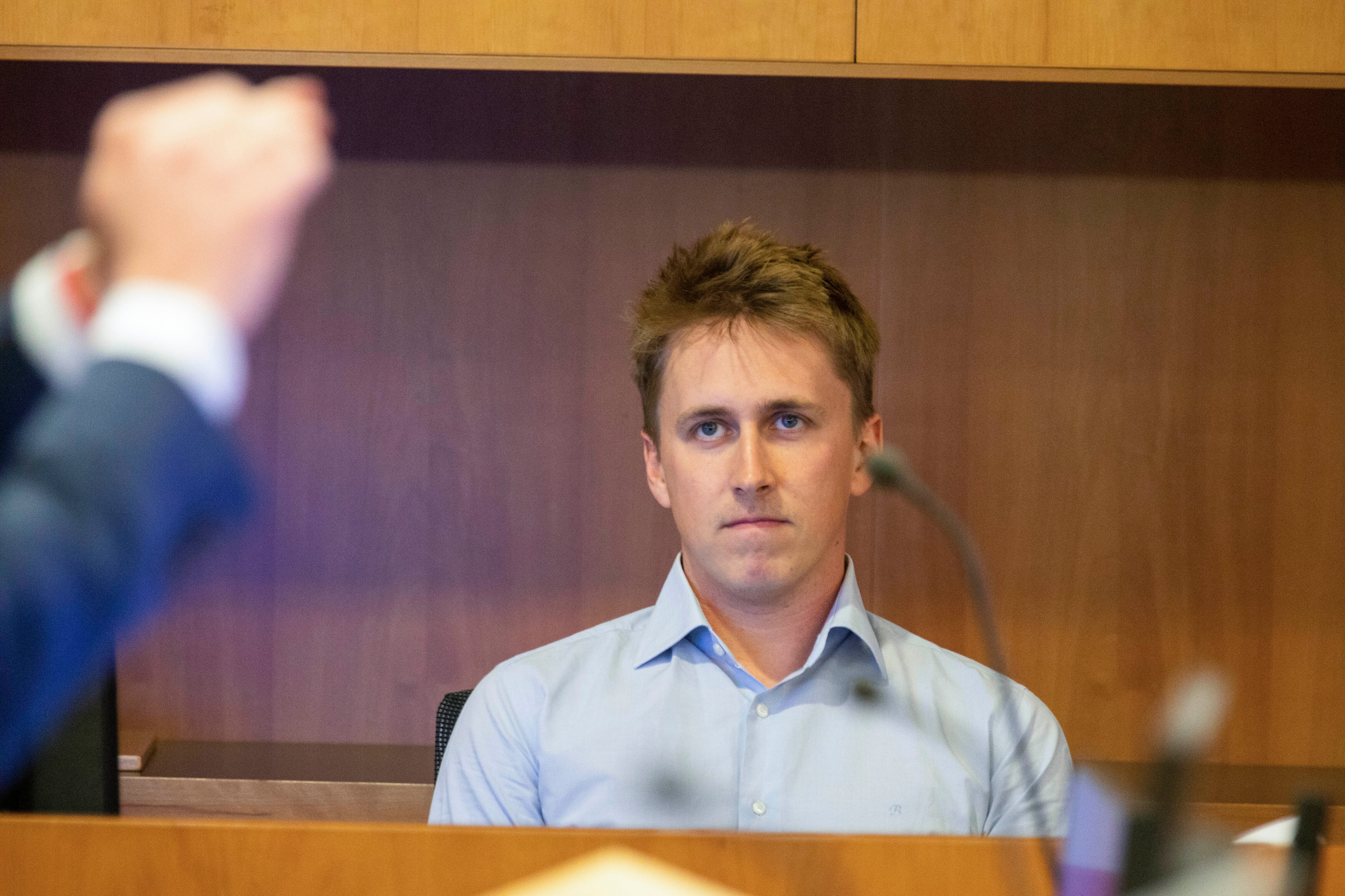 Pilot Brian Depauw reacts in the witness box at the Whakaari White Island eruption trial