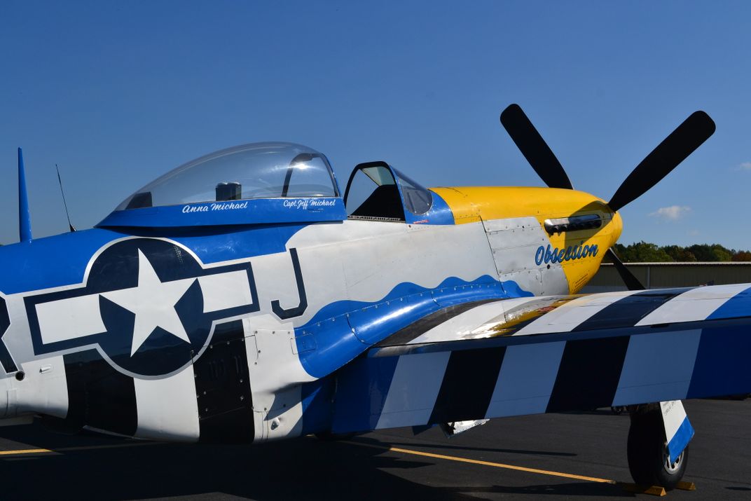 6 - The P-51 Mustang Obsession airplane, with its distinctive yellow, blue, black and white coloring, is a crowd-pleaser at air shows.