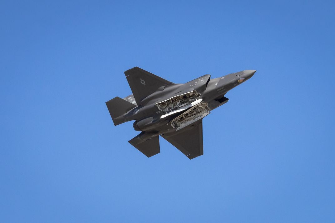 3 - At the Pikes Peak Regional Air Show, a fighter jet flies overhead with its two missile bays open.