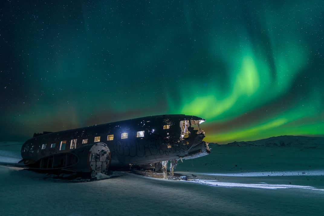 2 - When a U.S. Navy airplane crashed at Solheimasandur beach in 1973, the passengers survived, but the craft was abandoned to the elements. Decades later, the northern lights dance over the wreckage.